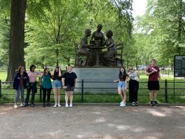 Students stand in front of New York monument to Women's Rights Pioneers