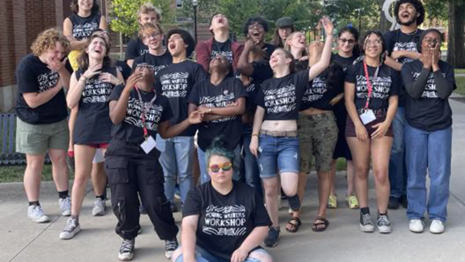 The participants of the 2023 Young Writers Workshop laughing and smiling together
