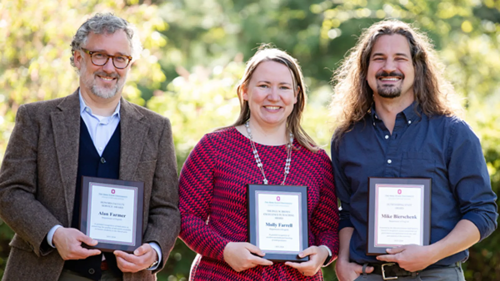 Alan Farmer, Molly Farrell, and Mike Bierschenk smile and display their award plaques