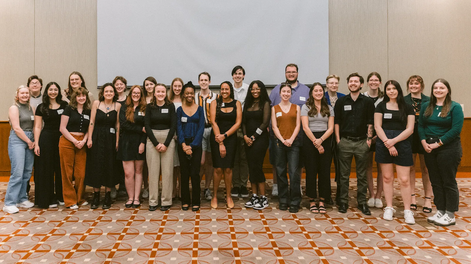 A large group of smiling young people gathered for a group portrait
