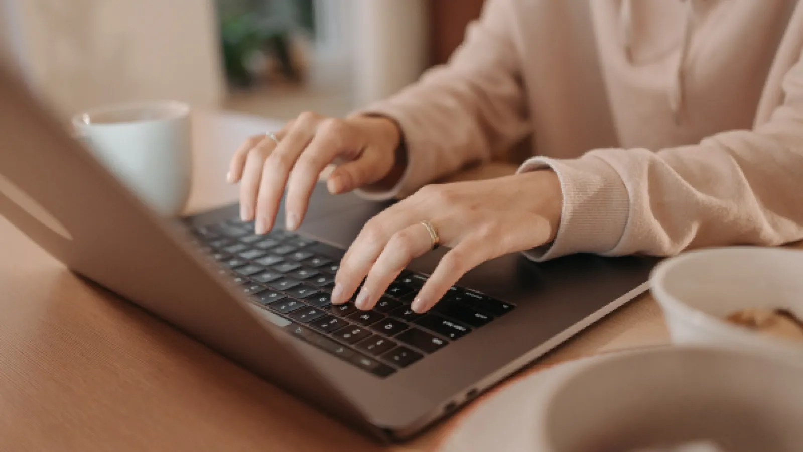 Someone typing on a laptop