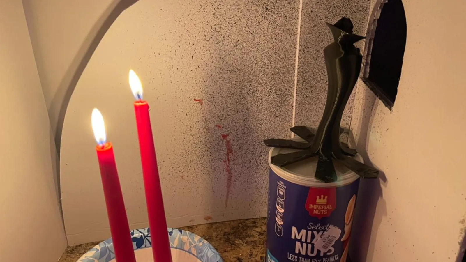 A short film still of bloodied candles.