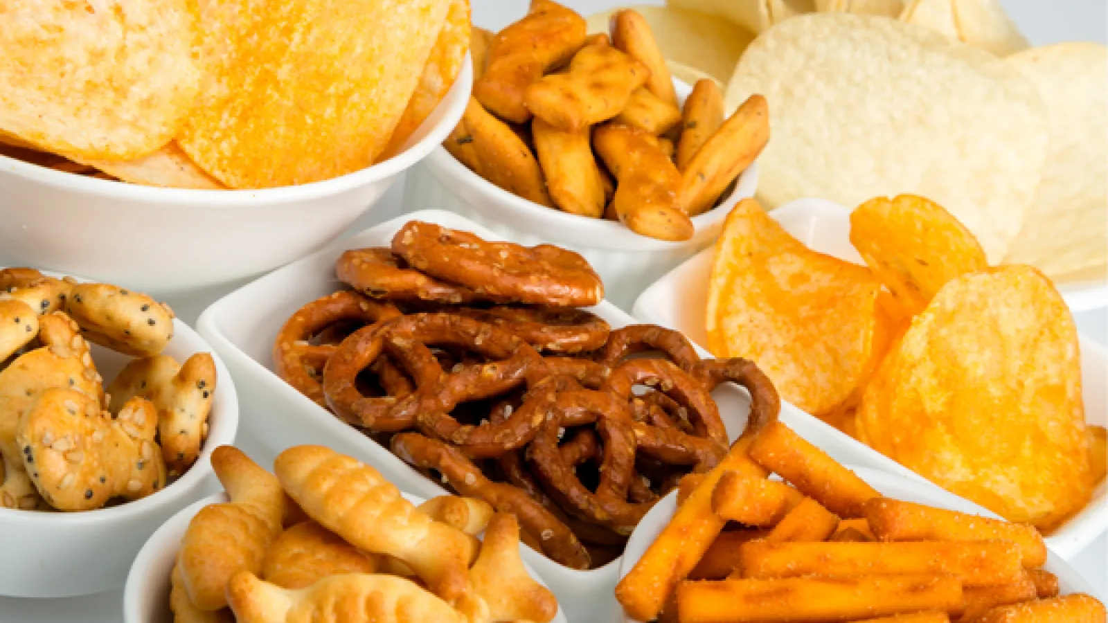 Assorted snacks such as chips and pretzels.