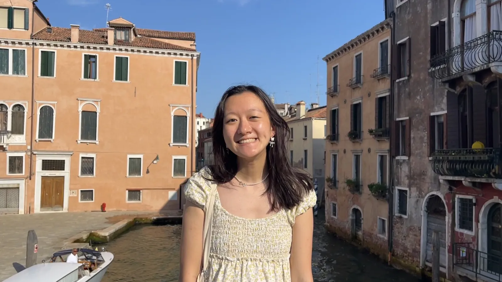 Sunny Jiang standing on bridge, buildings behind her.