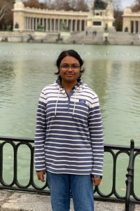 Undergraduate Deepal Nadar stands in front of a pond