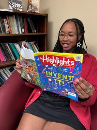 Student reading Highlights magazine