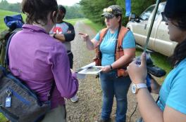 Two students interview a person outside