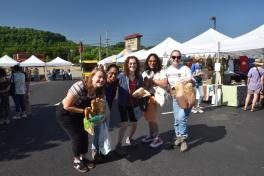 Five students pose outside Athens farmer's market