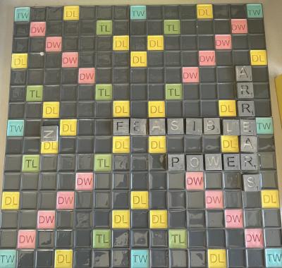3d printed scrabble board with tiles that read "arrears, feasible, power"