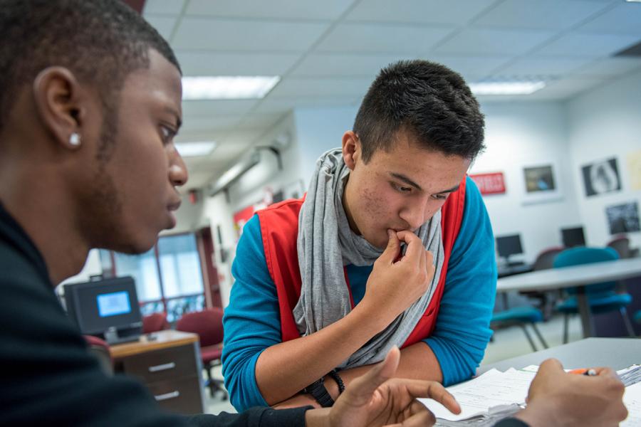 students looking over writing project