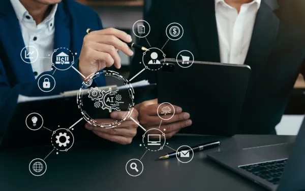  a hand and an ipad with a web of symbols related to hybrid meetings
