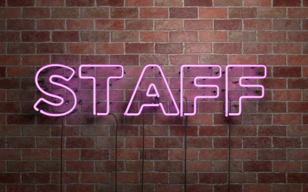 Staff written in pink neon letters