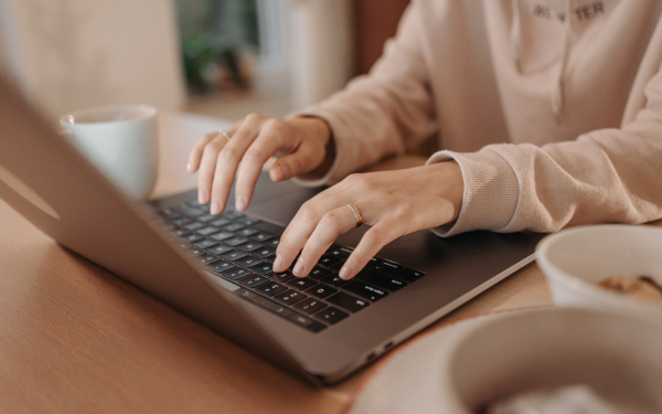 Someone typing on a laptop