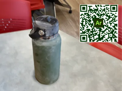 A VR Hydroflask water bottle sitting on a table. 