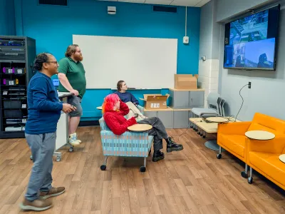 Digital Media Project staff members play Halo 3 on the Xbox 360