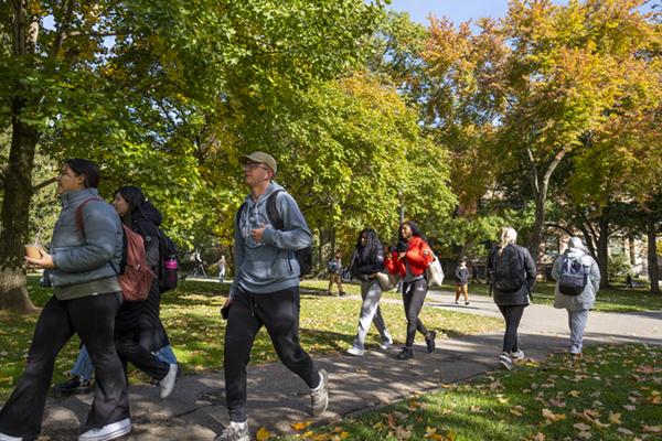 Students walk across the Oval on an early fall day