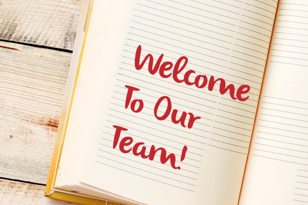 Book with the words welcome to our team on the book's page