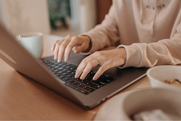 Someone typing on a laptop