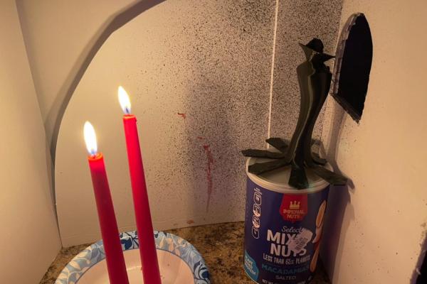 A short film still of bloodied candles.