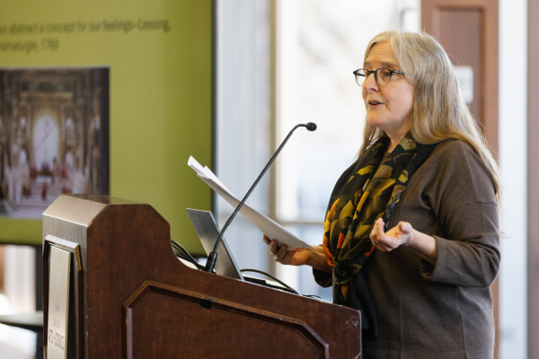 Dorothy Noyes speaking into a microphone. 