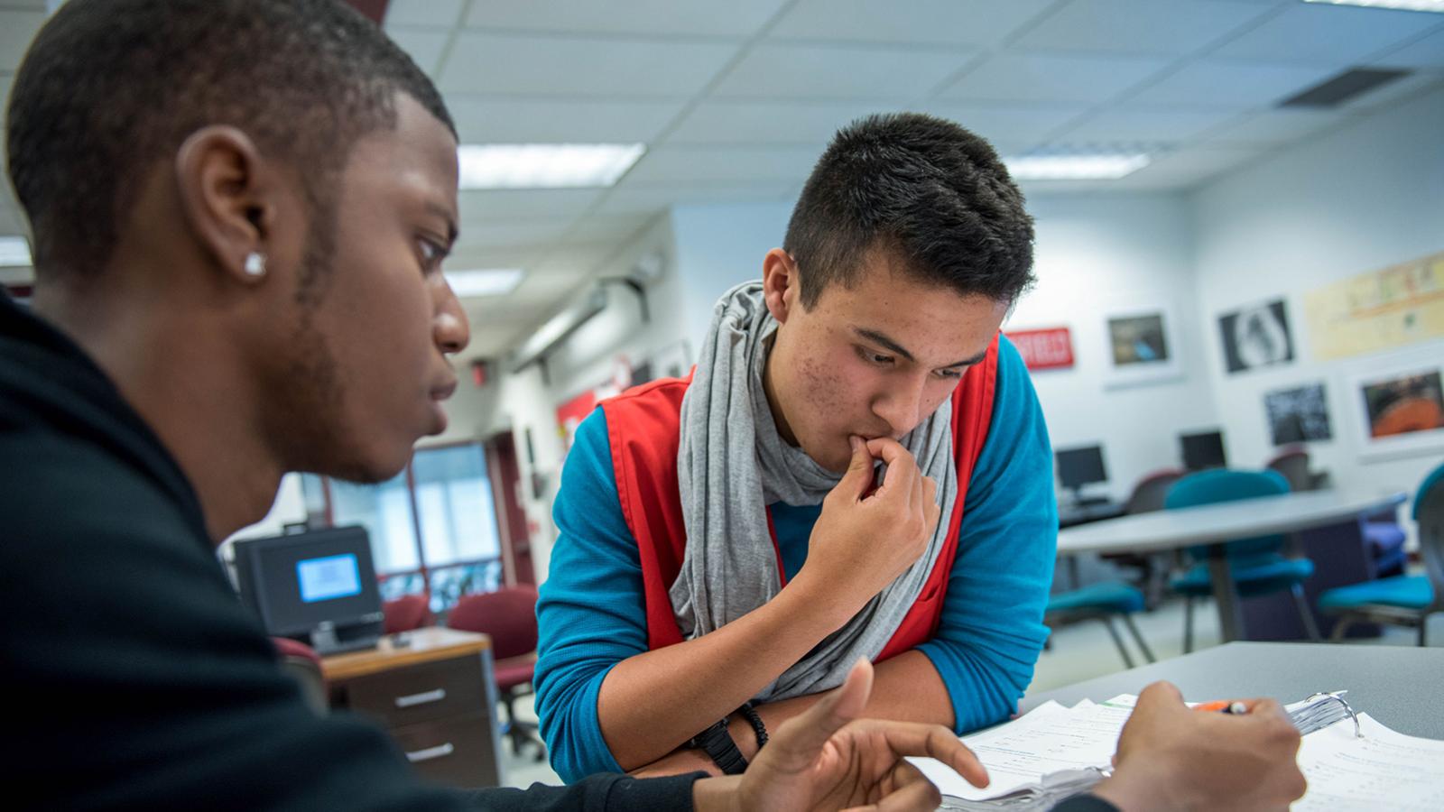 students looking over writing project