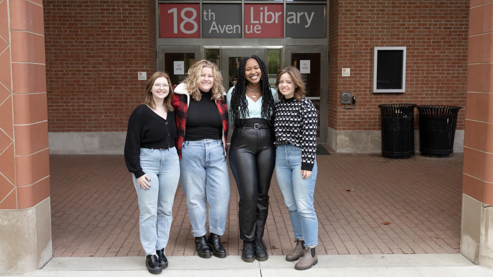 Four students standing outside 18th Avenue Library