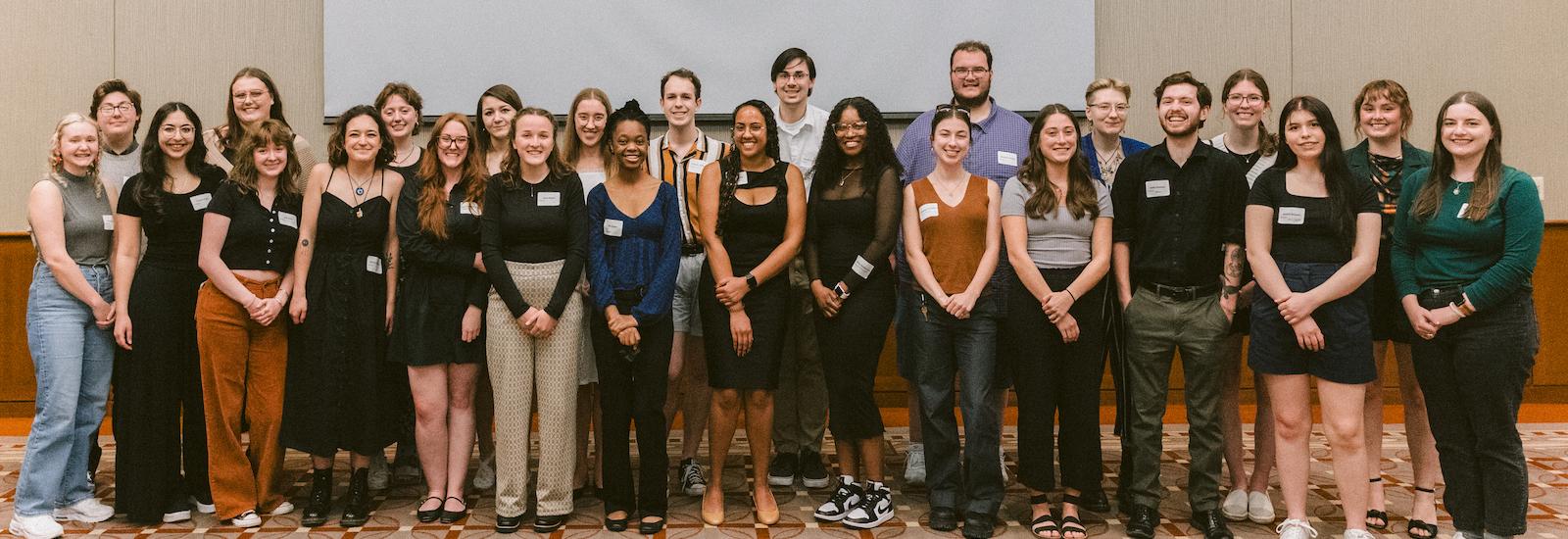 A large group of smiling young people gathered for a group portrait